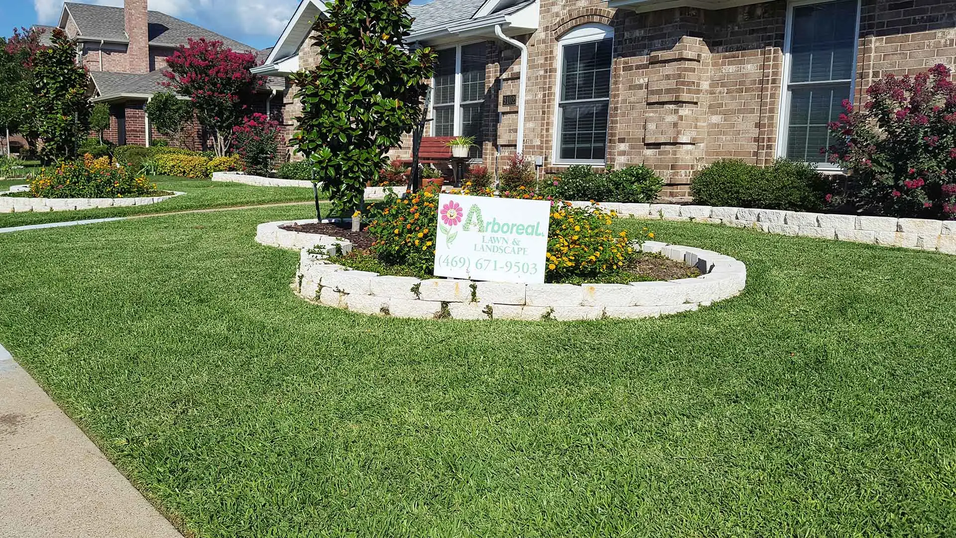 Beautiful lawn with green grass and lawn service sign near Rockwall, TX.