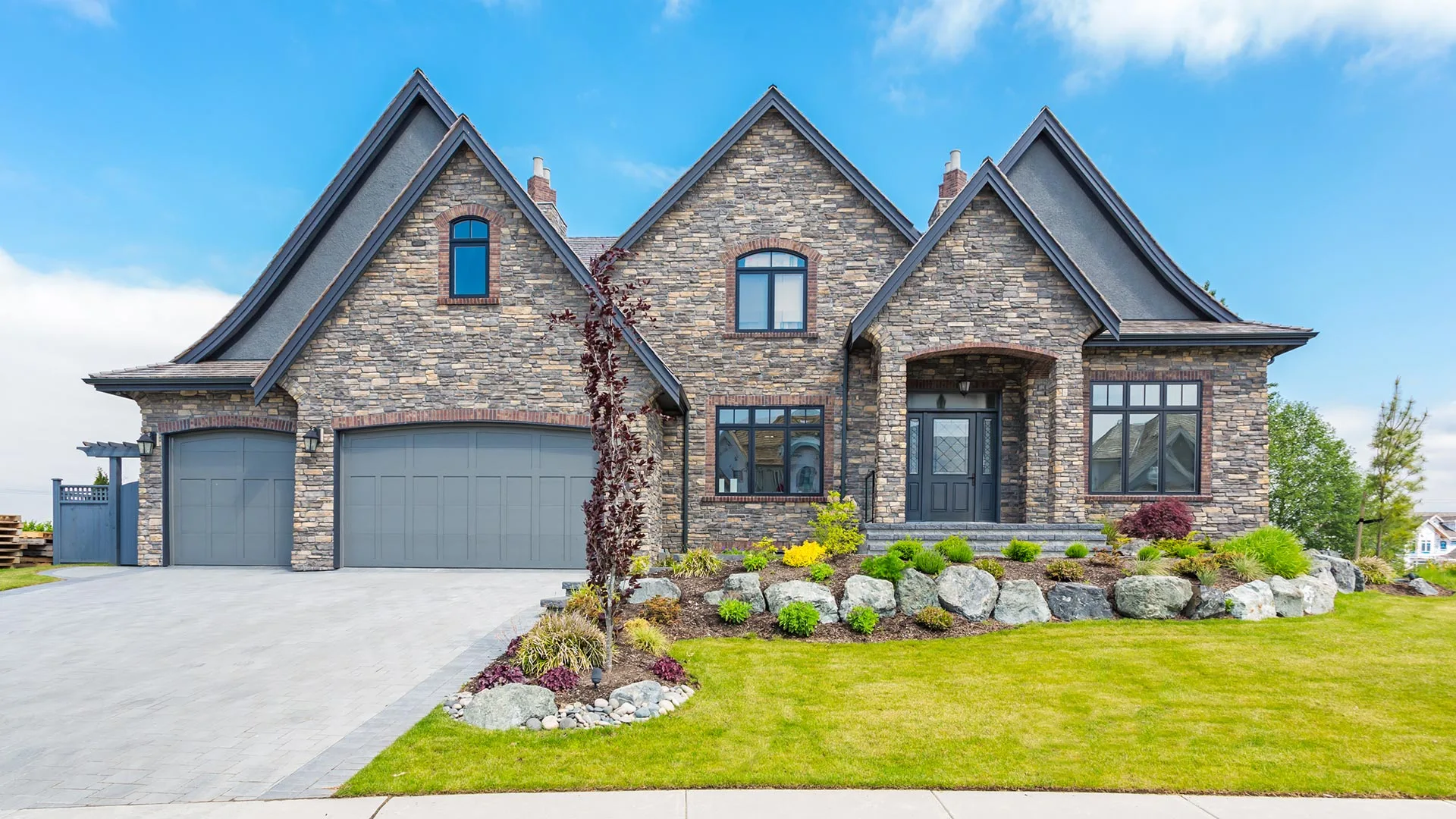 A stone home with a healthy lawn in Heath, TX.