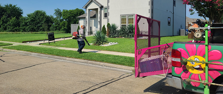Arboreal employee outside of company truck servicing a customer's lawn in Rockwall, TX.