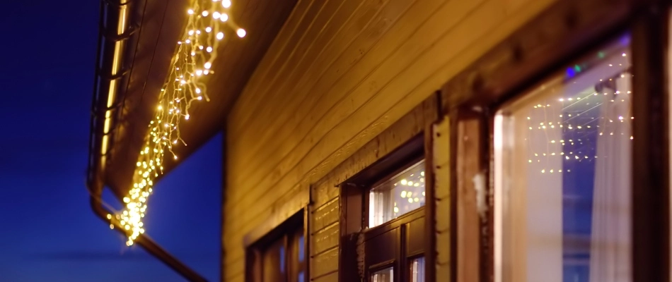 White icicle string lights hung up by Arboreal professionals in Wylie, TX.