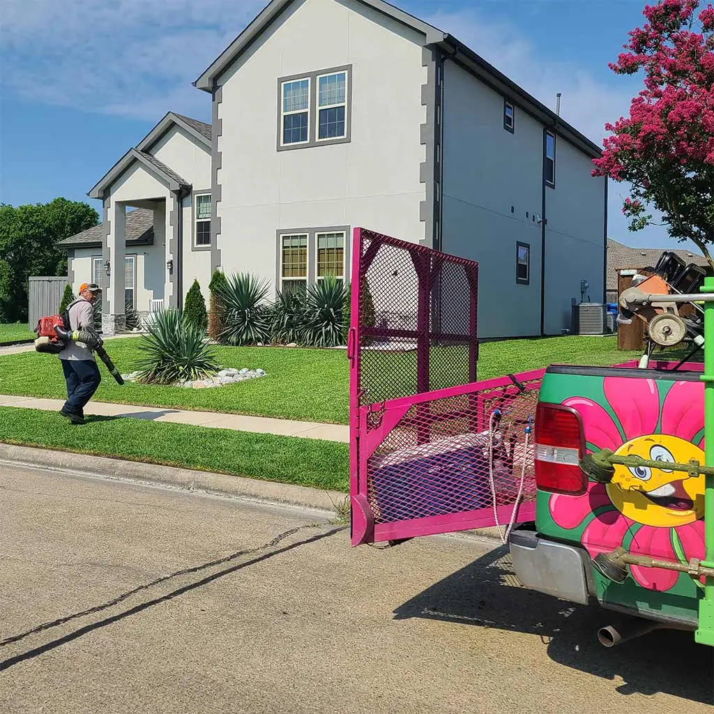 Lawn care expert with a leaf blower near Rockwall, Texas.